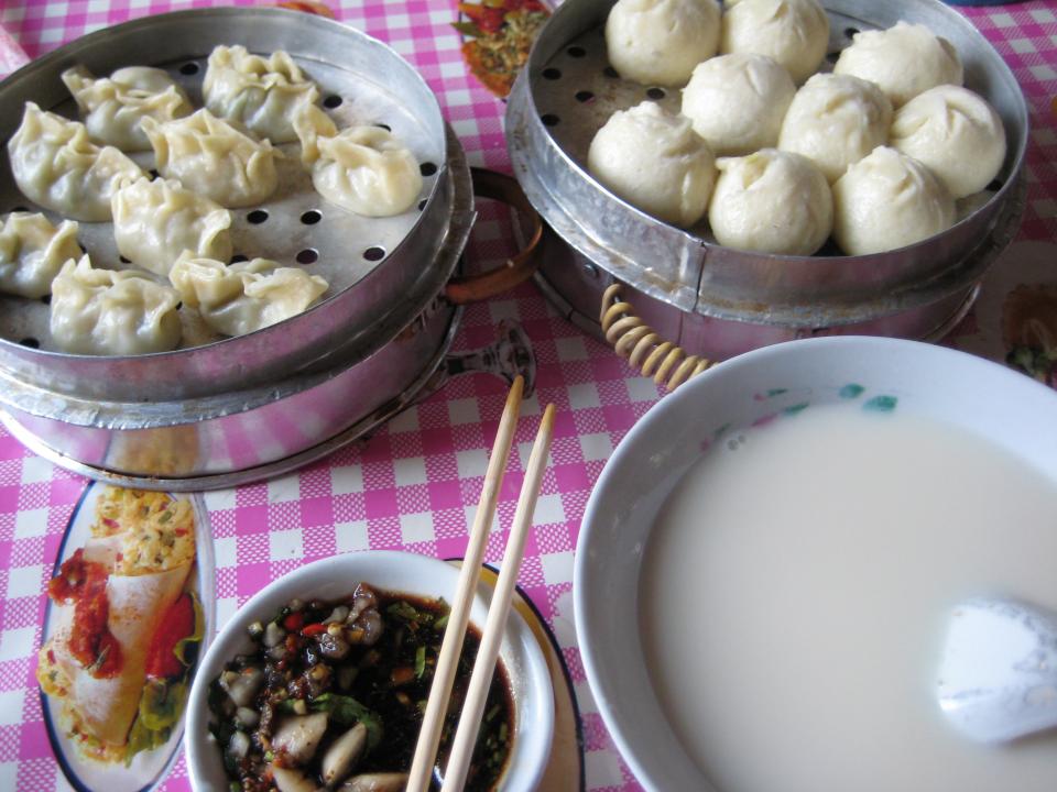 Breakfast - from top left, clockwise: zhengjiao, baozi, doujiang, soy sauce-based dip